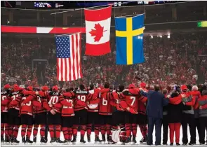  ?? ?? The Associated Press
Team Canada players and staff sing O Canada after winning gold against Sweden at the World Junior championsh­ips in Buffalo, N.Y., on Jan. 5, 2018.