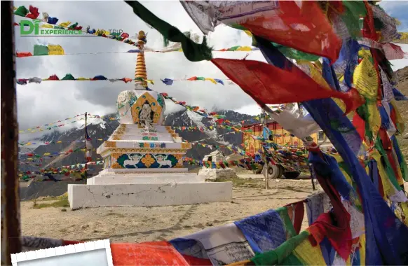  ??  ?? From top: The age-old temple at Kumzum Pass is peppered with prayer ﬂags; Tibetan mani stones with Buddhist mantras. Opposite, from top left: Komic is the highest village in the world connected to motorable road; Langza is home to both soaring peaks and sweeping lush ﬁelds.