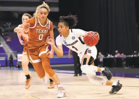  ?? Carmen Mandato / Getty Images ?? South Carolina’s Zia Cooke drives to the basket against Texas’ Celeste Taylor during their Elite Eight game in San Antonio.