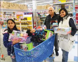  ?? Ernest A. Brown photo ?? Oviya Ramadrisha­nasamy, 11, and her cousin, Samarth Saravaman, 3, of Dallas, shop for toys with Yodhram Sharma and Parvati Sharma, of Hopkington, Mass. at the Toys “R Us in Bellingham where everything is marked up to 60 percent off due to the store’s...