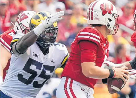  ?? ?? University of Michigan Wolverines’ David Ojabo sacks Wisconsin’s Graham Mertz during a NCAA college game in Madison, Wisconsin in October last year