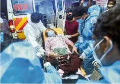  ?? —AFP ?? Medical attention:
Health workers transferri­ng an injured passenger from an ambulance toa hospital in Kozhikode.