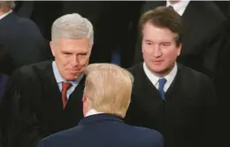  ?? MARIO TAMA/GETTY ?? President Donald Trump greets Supreme Court Justice Neil Gorsuch, alongside Justice Brett Kavanaugh, ahead of the State of the Union address in 2020.