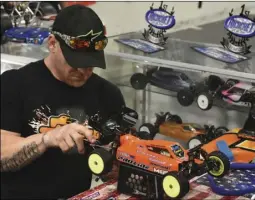  ??  ?? Jayson Soyko, of Scottsdale, Ariz., makes a last-minute adjustment to his RC car, prior to the start of his next race Sunday at the 4th annual Pro-Line Carpet Classic at Ricochet R/C Raceway in Imperial. PHOTO TOM BODUS