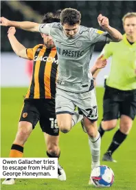  ??  ?? Owen Gallacher tries to escape from Hull’s George Honeyman.