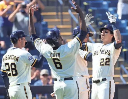  ?? ROY DABNER / FOR THE JOURNAL SENTINEL ?? Milwaukee's Christian Yelich, shown celebratin­g with Lorenzo Cain after hitting a grand slam, is looking to have a banner season after last year's struggles.