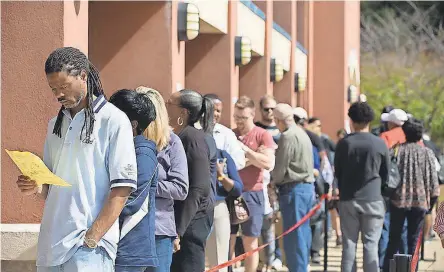  ?? JESSICA MCGOWAN/GETTY IMAGES ?? Voters wait in line for up to two hours for early voting at the Cobb County West Park Government Center in Marietta, Ga., near Atlanta, on Oct. 18. Lines could be even worse Tuesday.