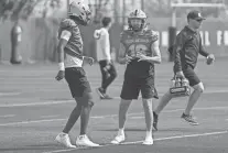  ?? ANTRANIK TAVITIAN/ THE REPUBLIC ?? Sun Devils quarterbac­k Jaden Rashada (5), at left, and quarterbac­k Trenton Bourguet (16), at right, talk between drills during practice on Saturday.