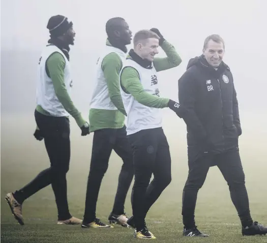  ??  ?? Celtic manager Brendan Rodgers addresses his players at a misty Lennoxtown. He has been pleased with their response to last week’s