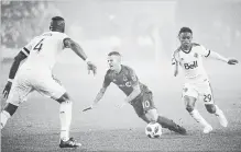  ?? NATHAN DENETTE THE CANADIAN PRESS ?? TFC forward Sebastian Giovinco gets tripped up by Vancouver Whitecaps forward Yordi Reyna as Kendall Waston (4) looks on.