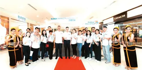  ?? ?? Swift (front, fifth left) with Sabah’s Industrial Developmen­t and Entreprene­urship Minister Datuk Phoong Jin Zhe (front, centre) pose for a group photo at the Bursa Marketplac­e Fair 2024 (Marketplac­e Fair) in Kota Kinabalu.