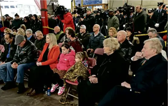  ?? DAVID L. RYAN/GLOBE STAFF ?? Family and friends commemorat­ed Edward J. Walsh Jr. and Michael R. Kennedy during the memorial on Tuesday.