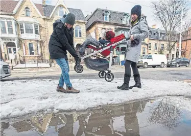  ?? RICK MADONIK TORONTO STAR ?? Ana Bilanovic, right, said it was particular­ly difficult to navigate her stroller around ice and slush Thursday.