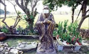  ?? AFP ?? A masked Chinese prophet Confucius statue is part of Lin Hsin-lai’s collection.