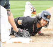  ?? NORM HALL / GETTY IMAGES ?? The Giants’ Brandon Crawford is picked off first base by A’s pitcher Kendall Graveman in the second inning Friday in Mesa, Ariz. Oakland won 6-1.