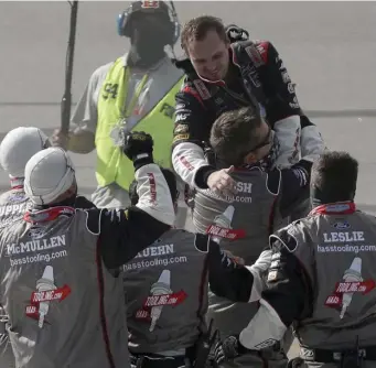  ??  ?? Cole Custer (top) celebrates with his crew after winning a NASCAR Cup Series race at Kentucky Speedway on Sunday.