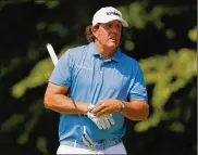  ?? KEVIN C. COX/GETTY IMAGES ?? Phil Mickelson watches his shot from the second tee in the first round of the Tour Championsh­ip last Thursday at East Lake Golf Club in Atlanta.