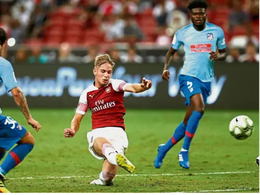  ??  ?? Sharp shooter: Arsenal’s Emile Smith Rowe scoring against Atletico Madrid during the Internatio­nal Champions Cup match at the Singapore National Stadium on Thursday. — Reuters