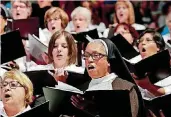  ?? [PHOTO BY JIM BECKEL, THE OKLAHOMAN ARCHIVES] ?? Sister Veronica Higgins sings Sept. 24 with others in the choir providing liturgical music for the beatificat­ion Mass for the Rev. Stanley Rother at the Cox Convention Center.