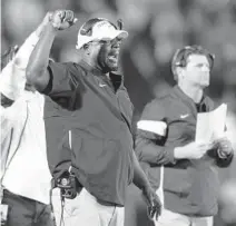  ?? BARRY REEGER/AP ?? New Florida Gators assistant coach Sean Spencer, left, shown in 2019 with Penn State, coached the defensive line for the New York Giants the last two seasons.