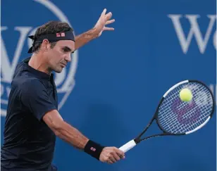  ?? AP PHOTO ?? Roger Federer returns to Peter Gojowcyzk at the Western &amp; Southern Open tennis tournament on Tuesday in Mason, Ohio.