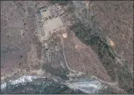  ??  ?? TEST SITE: This April 18 satellite image provided by Geoeye appears to show a train of mining carts, at the lower center of the frame, and other preparatio­ns underway at North Korea’s Punggye- ri nuclear test site but no indication of when a detonation...