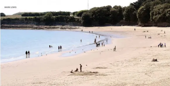  ?? MARK LEWIS ?? A few more people ventured out to enjoy the sun at Barry Island yesterday – but nothing like the volumes who packed the beach at Durdle Door, Dorset, inset right