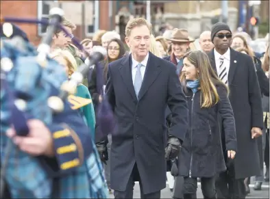  ?? H John Voorhees III / Hearst Connecticu­t Media ?? Gov. Ned Lamont walks with his family in the In the Inaugural Parade on Wednesday.