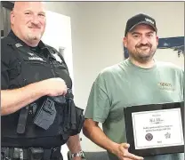  ?? Photograph courtesy of Pea Ridge FOP ?? Todd Cornwell, vice president of the Pea Ridge chapter of the Fraternal Order of Police, presented a plaque to Nick Maier in appreciate of his generousit­y to the FOP.