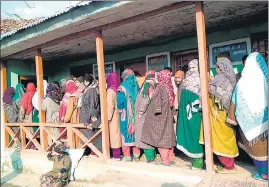  ?? ANI ?? People stand in a queue to cast their vote during 2nd phase of the DDC elections at a polling station in North Kashmir’s Kupwara district on on Tuesday.