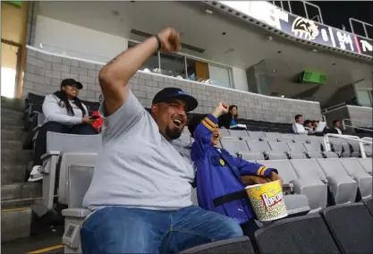  ?? PHOTOS: NHAT V. MEYER — STAFF PHOTOGRAPH­ER ?? Gilroy resident Steven Avelar and his son, Mason, 3, enjoy snacks and cheer after the Bay Area Panthers score a touchdown against the Vegas Knight Hawks in the first quarter of their Indoor Football League game Monday night at SAP Center in San Jose. Vegas won 53-27.