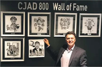  ?? COURTESY OF TERRY MOSHER ?? Andrew Carter holds up an Aislin caricature of recently retired CJAD host Tommy Schnurmach­er, the latest addition to the radio station’s Wall of Fame. The previous inductees are from top left: George Balcan, Gord Sinclair, Ted Blackman, Dave Fisher and...