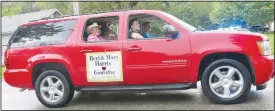  ?? (NWA Democrat-Gazette/Susan Holland) ?? Berl Dean and Mary Harris smile and wave to the crowd as they ride near the front of the parade. The Harrises were selected as parade marshals.