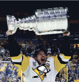  ?? GETTY IMAGES FILE PHOTO ?? Sidney Crosby of the Pittsburgh Penguins celebrates with the Stanley Cup after they defeated the Predators, 2-0, to win the NHL championsh­ip at the Bridgeston­e Arena in Nashville last June 11.