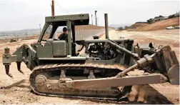  ?? PICTURE: AP ?? DIRTY PLAN: A California Army National Guardsman grades dirt with a tractor next to the second US-Mexico border fence in San Diego.