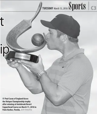  ?? AFP PHOTO ?? Paul Casey of England kisses the Valspar Championsh­ip trophy after winning at Innisbrook Resort Copperhead Course on March 11, 2018 in Palm Harbor, Florida.