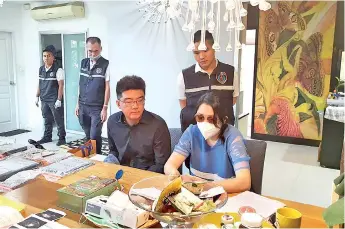  ?? — AFP photo ?? A Chinese couple arrested in connection with a surrogacy ring in an undisclose­d location in Thailand.