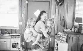  ?? Leah Nash / New York Times ?? Uncertaint­y over schools and child care has Brianna McCain, shown with her daughters Lincoln Manning, 2, and Nyla Manning, 6, rethinking going back to work.