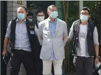  ??  ?? Media tycoon Jimmy Lai, centre, was arrested last August