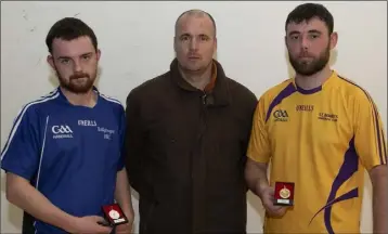  ??  ?? Matthew Hynes of St. Mary’s (right), winner of the Junior ‘C’ singles title, with runner-up Liam Rossiter (Ballyhogue) and official Barry McWilliams at the final in St. Joseph’s on Wednesday.