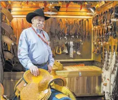  ??  ?? Tommy Conway of Cowboy Up Saddles displays his custom-made saddles and other accessorie­s at Cowboy Christmas.