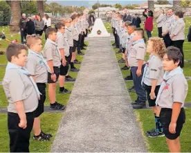  ??  ?? St Mary’s Scouts form a guard of honour at a retreat service on Anzac Day in Levin.