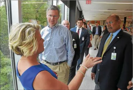  ?? PETE BANNAN — DIGITAL FIRST MEDIA ?? Saint-Gobain’s Tamara Mueller speaks with state representa­tives Harry Lewis, R-74th Dist. and Warren Kampf, R-157th Dist. during a tour of the company’s LEED Platinum award Malvern headquarte­rs.