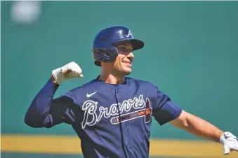  ?? AP PHOTO/GERALD HERBERT ?? Atlanta Braves first baseman Matt Olson celebrates after hitting a two-run homer against the Minnesota Twins during an exhibition game at spring training on Saturday in North Port, Fla.