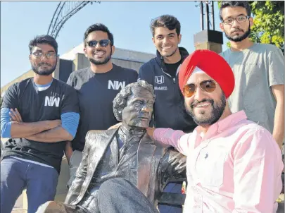  ?? STEPHEN BRUN/THE GUARDIAN ?? Gagandeep Sehgal, seated, and his team from Namaste World, from left, Prashanth Gunti, Vimal Ramaka, Alkarim Bhalesha and Adi Vella, ham it up with the statue of Sir John A. Macdonald in Charlottet­own. Their new website profiles immigrant successes in...