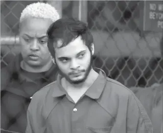  ?? LYNNE SLADKY THE ASSOCIATED PRESS ?? Esteban Santiago is escorted from the Broward County jail for an arraignmen­t in federal court in Fort Lauderdale, Fla. Santiago pleaded guilty in exchange for a life prison sentence in the January 2017 shooting .