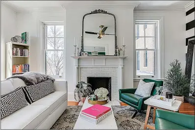 ??  ?? Seating in Louisa Bargeron’s living room is arranged around the original fireplace and mantel.