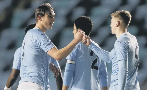  ??  ?? Callum Doyle (left) celebrates with his Manchester City team mates.