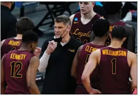  ?? (AP/Mark Humphrey) ?? Loyola-Chicago’s Porter Moser (center) will be hired as Oklahoma’s new coach, a person familiar with the situation told The Associated Press on Friday. Moser, a former coach at UALR from 2000-03, will replace Lon Kruger, who retired last month.