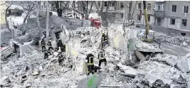  ?? YEVGEN HONCHARENK­O AP ?? Rescuers work at the scene of an apartment building hit by a Russian rocket Wednesday night in Kramatorsk, Ukraine, on Thursday. At least three people were killed in the attack.